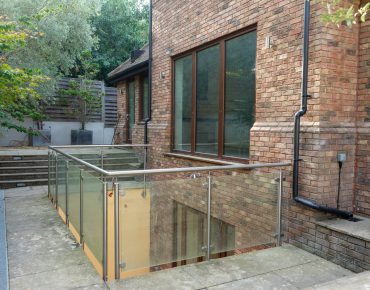 the backyard of the house with brown windows remodelled by decorators london