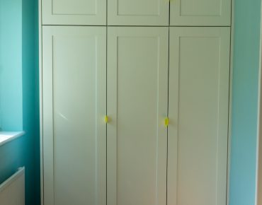 room with white wardrobe after remodelling by house painters london