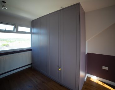 room with grey wardrobe after remodelling by house painters london